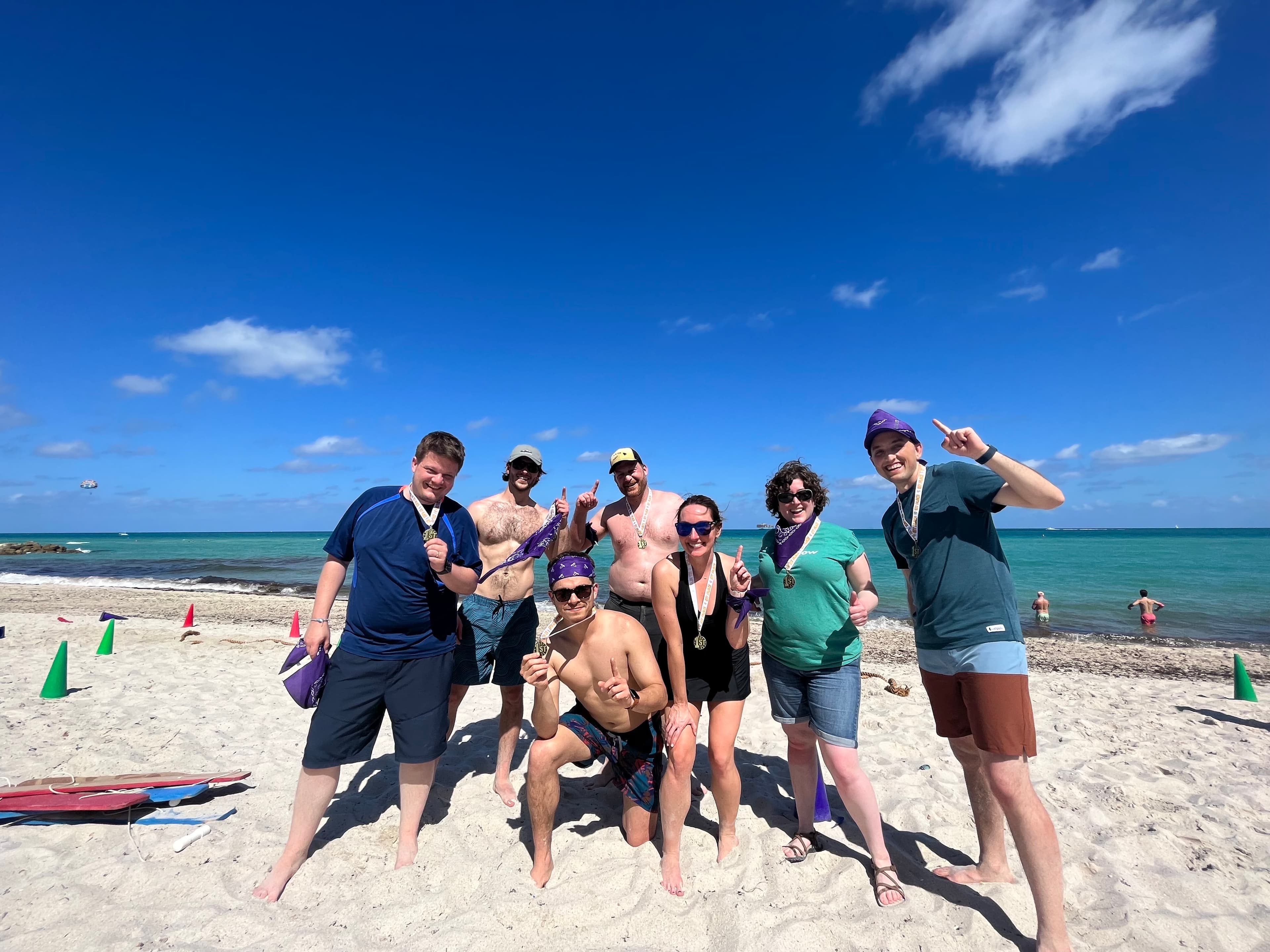 Kate and teammates celebrating together on a beach
